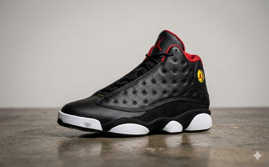 Black and red sneaker with a yellow logo on a gray background